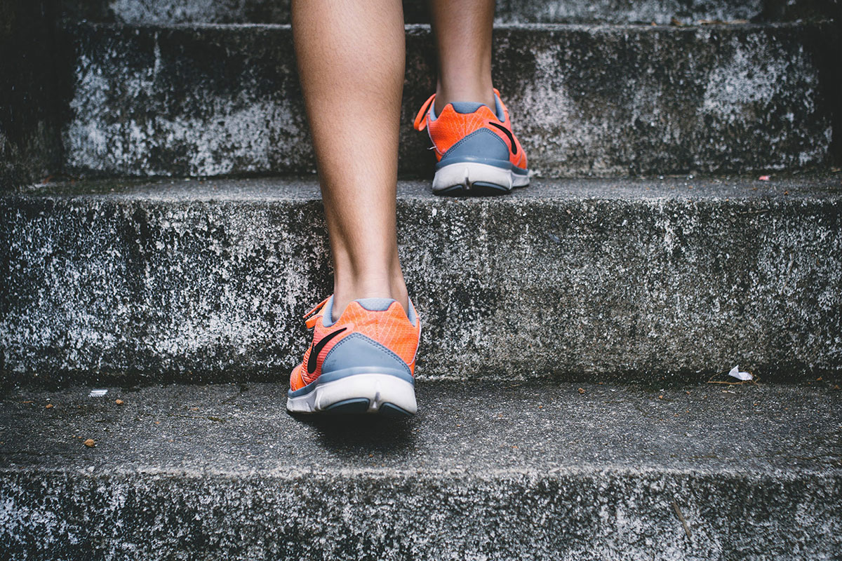 picture of woman walking up stairs outside